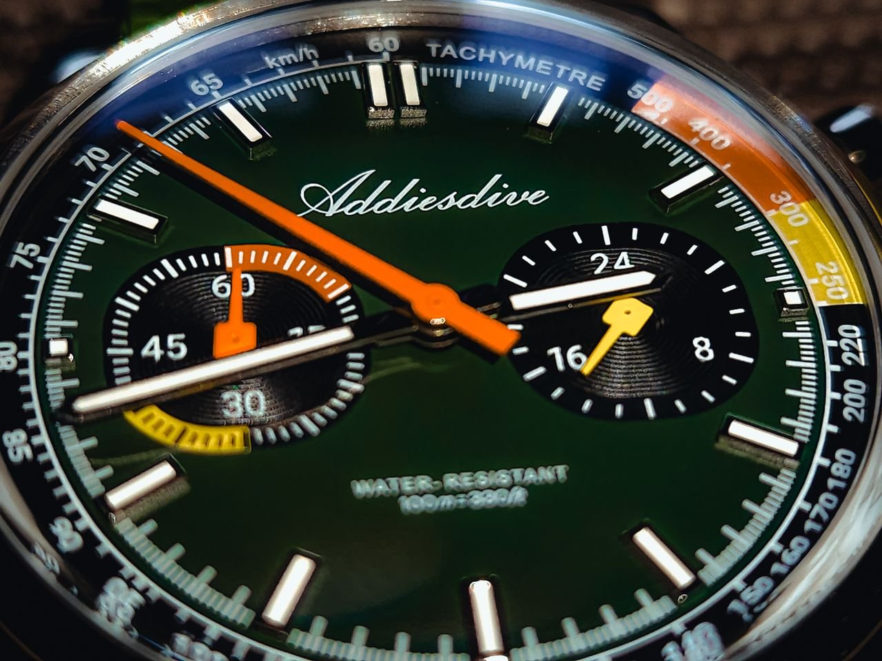 Detailed view of Addiesdive wristwatch showcasing tachymeter and vivid color scheme.